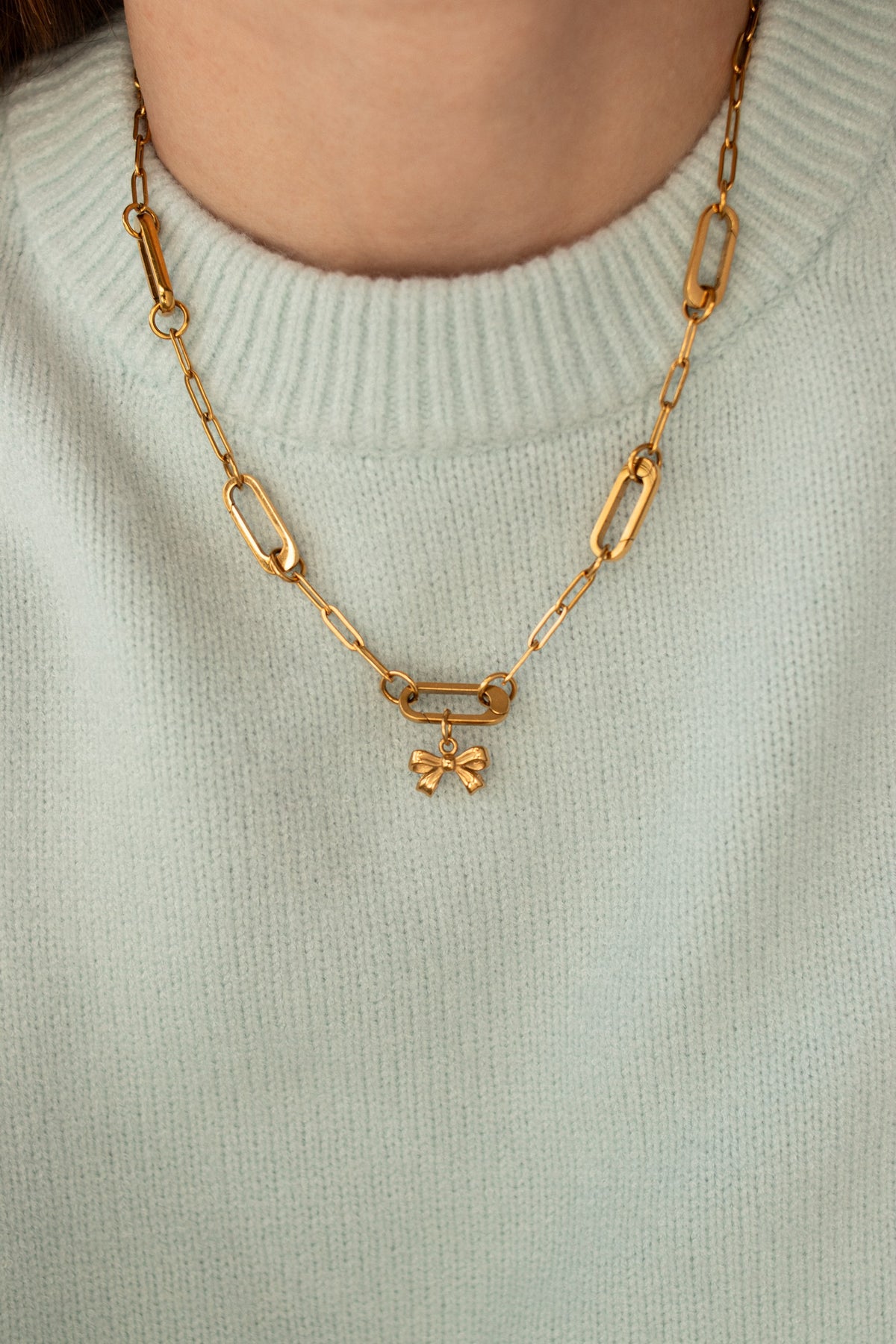 Little Bow Charm worn on a gold paperclip chain