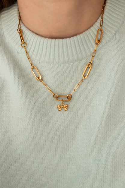 Little Bow Charm worn on a gold paperclip chain