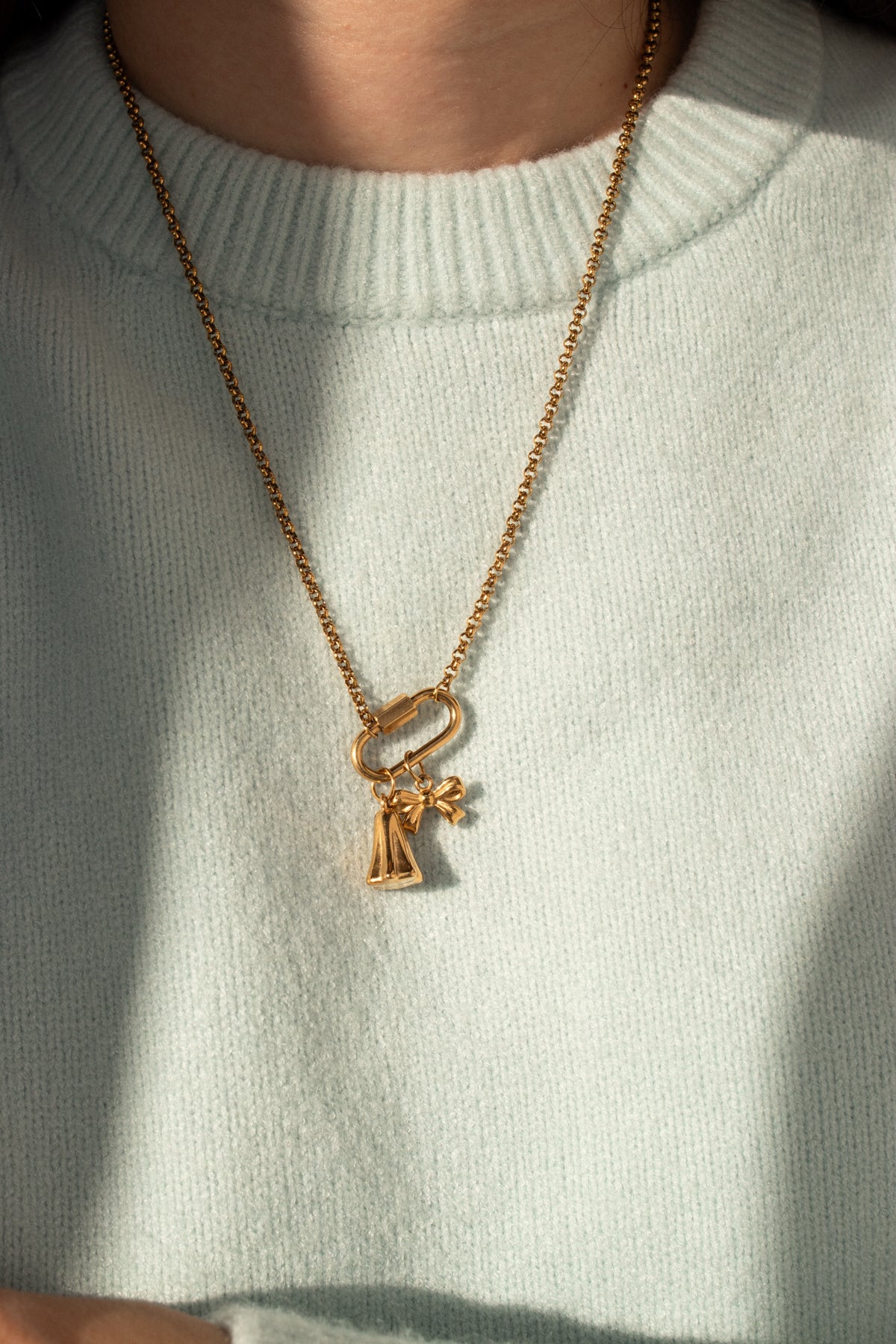 Little Ghost Charm worn with the Little Bow Charm on a gold rope chain