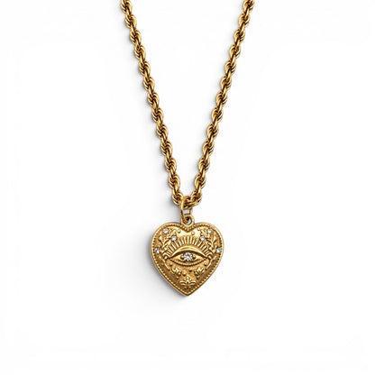 Gold heart pendant with a crystal-set eye at its centre on a rope chain