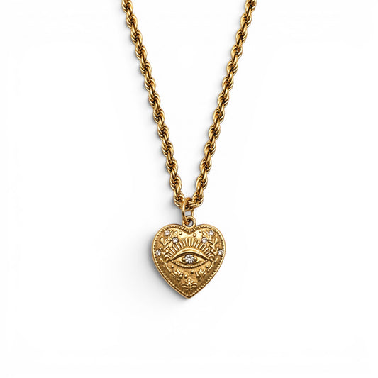 Gold heart pendant with a crystal-set eye at its centre on a rope chain