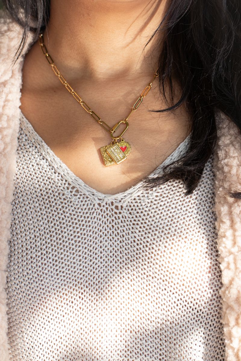 Biscuit charms on a gold clasp chain, close up