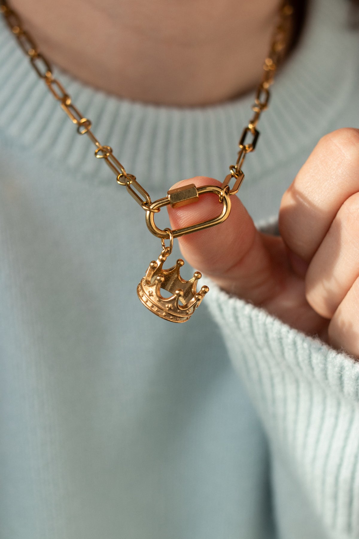The Crown Charm held up close on its clasp