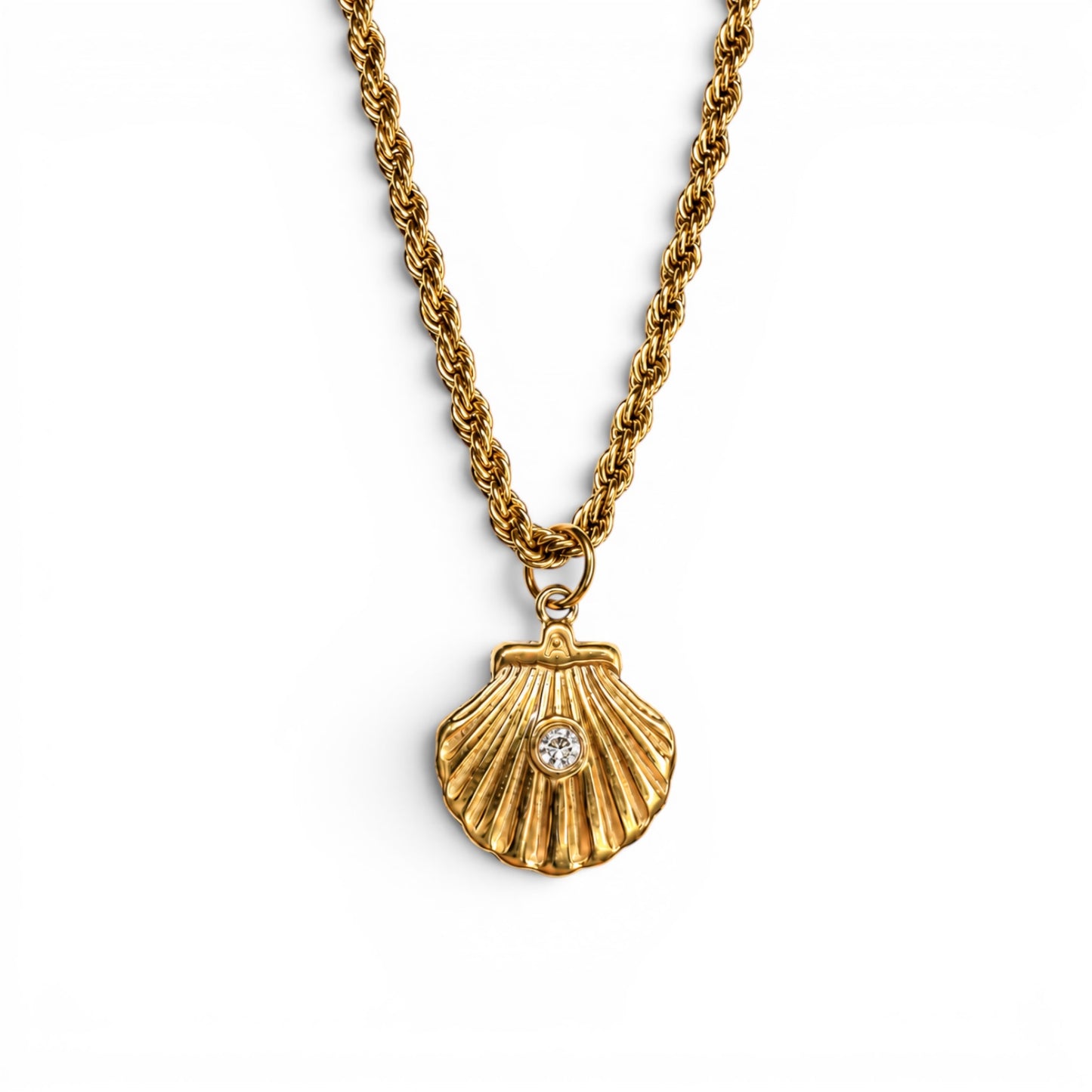 Reverse side of the gold scallop shell pendant set with a clear stone